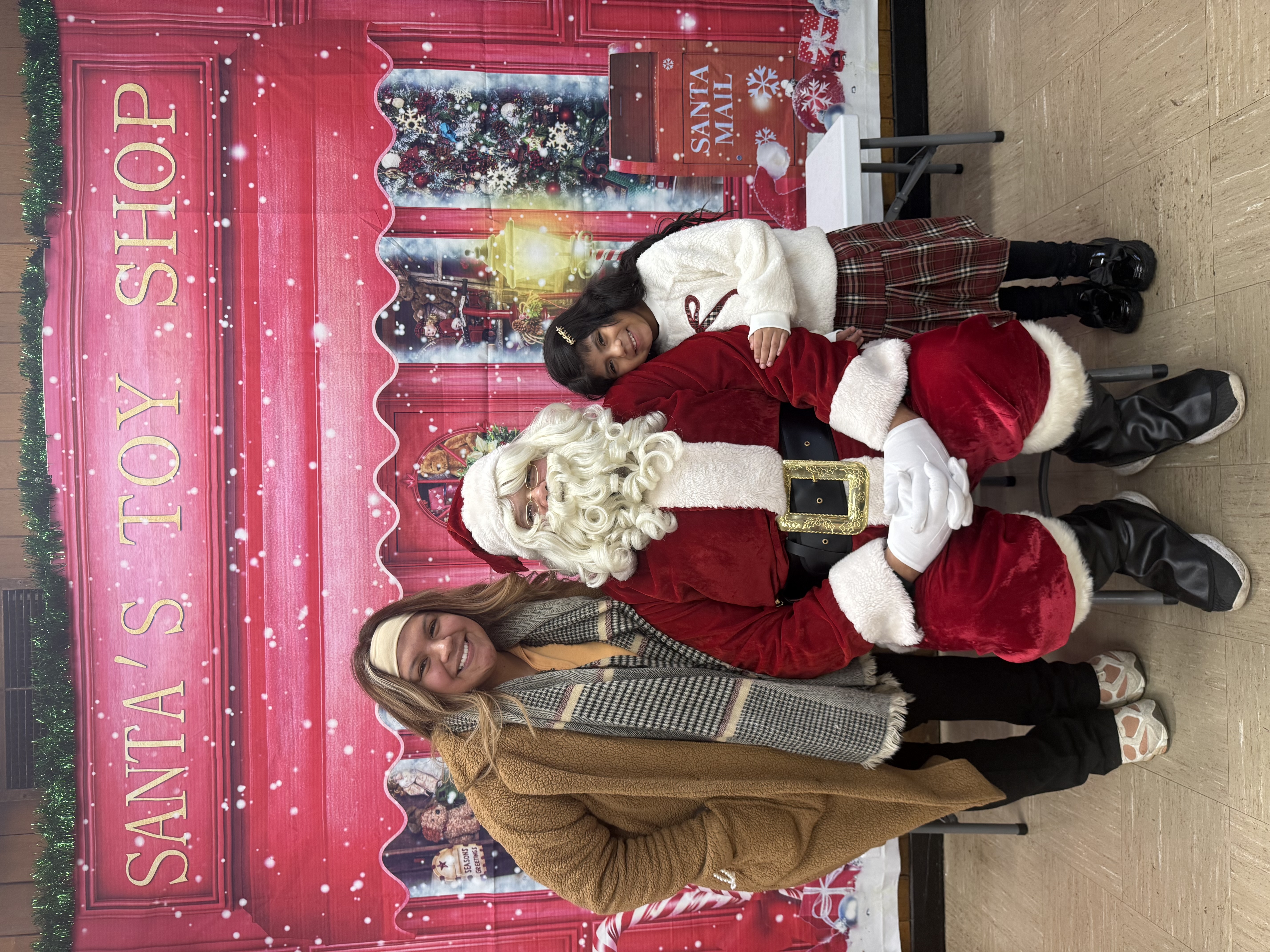 A photograph of Santa with two girls.